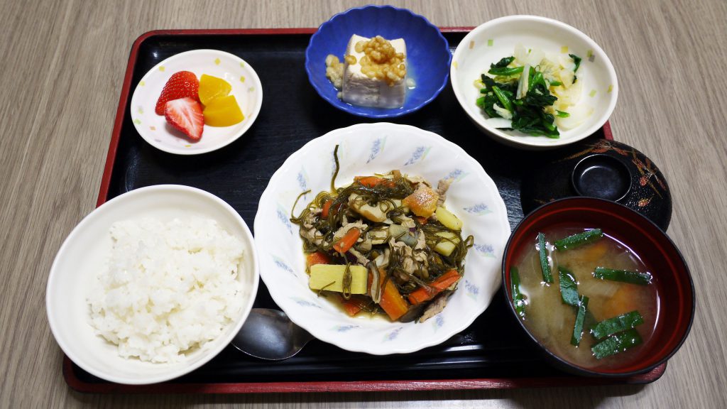 きょうのお昼ごはんは、豚肉と切り昆布の炒め煮、和え物、煮奴、みそ汁、果物でした。