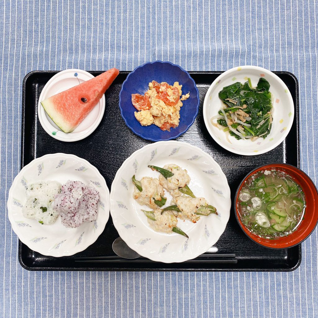 きょうのお昼ごはんは、花むすび・オクラの鶏つくね・トマトオムレツ・なめたけ和え・冷やし汁・くだものでした。